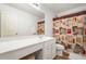 Bathroom with a single vanity, toilet and a shower with a colorful curtain at 1560 Avalon Creek Rd, Sugar Hill, GA 30518