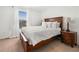 Bedroom features natural light, a wooden bed frame and side tables at 1560 Avalon Creek Rd, Sugar Hill, GA 30518