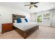 Bedroom with a ceiling fan, large bed and two windows allowing natural light at 1560 Avalon Creek Rd, Sugar Hill, GA 30518