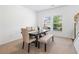 Bright dining room with large windows, a modern table with seating for six, and neutral carpeting at 1560 Avalon Creek Rd, Sugar Hill, GA 30518