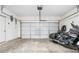 A garage with a motorcycle parked near a closed white garage door at 1560 Avalon Creek Rd, Sugar Hill, GA 30518