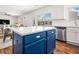 Bright kitchen features a blue island with white countertops and stainless steel appliances at 1560 Avalon Creek Rd, Sugar Hill, GA 30518