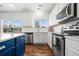 Bright kitchen with stainless steel appliances, ample counter space, and a view to the outdoors at 1560 Avalon Creek Rd, Sugar Hill, GA 30518