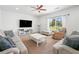 Spacious living room with large TV, comfortable seating, and a view of the front yard at 1560 Avalon Creek Rd, Sugar Hill, GA 30518