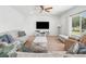 Spacious living room with comfortable seating, large windows, and neutral decor at 1560 Avalon Creek Rd, Sugar Hill, GA 30518