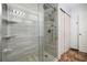 Updated shower with glass doors, rain shower head, and built in shelving at 1560 Avalon Creek Rd, Sugar Hill, GA 30518