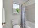 Bathroom features a shower/tub combo with tiled walls and floral shower curtain at 5303 Davenport Mnr, Cumming, GA 30041