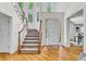 Bright and airy foyer with hardwood floors, a staircase, and large windows that flood the space with natural light at 5303 Davenport Mnr, Cumming, GA 30041