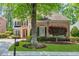 Brick home with manicured lawn, shade trees, and long driveway at 5303 Davenport Mnr, Cumming, GA 30041