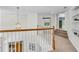 Bright hallway with a decorative chandelier, stairwell and built-in shelving at 5303 Davenport Mnr, Cumming, GA 30041