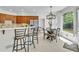Eat-in kitchen featuring stainless steel appliances, a breakfast bar, and a dining area with ample natural light at 5303 Davenport Mnr, Cumming, GA 30041