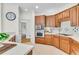Classic kitchen with wood cabinets, stainless steel appliances, and a tile backsplash at 5303 Davenport Mnr, Cumming, GA 30041