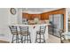 Bright kitchen featuring stainless steel appliances, a breakfast bar, and a cozy dining nook with large windows at 5303 Davenport Mnr, Cumming, GA 30041