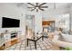 Bright living room showcasing hardwood floors, coffered ceilings, and an open layout connecting to the kitchen at 5303 Davenport Mnr, Cumming, GA 30041
