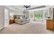 Large main bedroom with tray ceilings, large windows, ceiling fan and built-in shelving at 5303 Davenport Mnr, Cumming, GA 30041