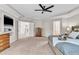 Large main bedroom with tray ceilings, dressers, ceiling fan and access to the main bath at 5303 Davenport Mnr, Cumming, GA 30041