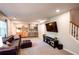 Finished basement featuring a large leather couch, a mini kitchen, and stairs at 110 Sandy Ridge Trl, Fayetteville, GA 30214