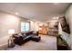 Finished basement with a large leather couch, a mini kitchen, a window, and recessed lighting at 110 Sandy Ridge Trl, Fayetteville, GA 30214