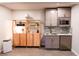 Basement kitchen with stainless steel refrigerator, updated cabinets, and a stainless steel sink at 110 Sandy Ridge Trl, Fayetteville, GA 30214