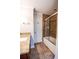 Bathroom with a shower and tub combination, featuring a glass sliding door and updated granite countertop vanity at 110 Sandy Ridge Trl, Fayetteville, GA 30214