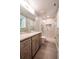 Modern bathroom with double sink vanity, walk-in glass shower and gray tile floor at 110 Sandy Ridge Trl, Fayetteville, GA 30214