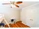 Bedroom featuring wood floors, a ceiling fan, storage, and a closet at 110 Sandy Ridge Trl, Fayetteville, GA 30214
