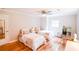 Shared bedroom featuring hardwood floors, two beds, ample natural light, and a ceiling fan at 110 Sandy Ridge Trl, Fayetteville, GA 30214