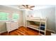 Cozy bedroom with a bunk bed, wood floors, large windows with natural light, and a ceiling fan at 110 Sandy Ridge Trl, Fayetteville, GA 30214