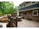 Wooden deck with dining area, brick exterior, and wooded view at 110 Sandy Ridge Trl, Fayetteville, GA 30214