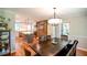 Spacious dining area featuring an elegant chandelier and a brick wall accent next to the kitchen at 110 Sandy Ridge Trl, Fayetteville, GA 30214