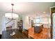 Bright dining area connected to the kitchen, featuring a dark wood table and hardwood floors at 110 Sandy Ridge Trl, Fayetteville, GA 30214
