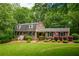 Charming brick home with lush landscaping, manicured lawn and dormer windows at 110 Sandy Ridge Trl, Fayetteville, GA 30214