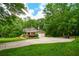 Beautiful home with well-manicured lawn, two-car garage, and a wide driveway surrounded by mature trees at 110 Sandy Ridge Trl, Fayetteville, GA 30214
