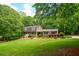 Charming brick home with lush, green lawn and mature trees creating an inviting curb appeal at 110 Sandy Ridge Trl, Fayetteville, GA 30214
