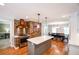 Open-concept kitchen features stainless steel appliances, an island, and a brick accent wall at 110 Sandy Ridge Trl, Fayetteville, GA 30214