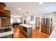 Well-lit kitchen features stainless steel appliances, an island, and a brick accent wall at 110 Sandy Ridge Trl, Fayetteville, GA 30214