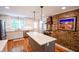 Well-lit kitchen features stainless steel appliances and a spacious island with stone countertops at 110 Sandy Ridge Trl, Fayetteville, GA 30214