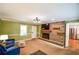 Cozy living room features a brick fireplace, modern lighting, and an open doorway to the kitchen at 110 Sandy Ridge Trl, Fayetteville, GA 30214