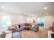 Bright and cozy living room featuring a large sectional sofa and natural light at 110 Sandy Ridge Trl, Fayetteville, GA 30214