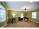 Spacious living room with bright green walls, carpeted floors, and modern lighting at 110 Sandy Ridge Trl, Fayetteville, GA 30214