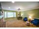 Inviting living room with comfortable seating and natural light streaming through a large bay window at 110 Sandy Ridge Trl, Fayetteville, GA 30214