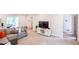 Spacious living room with an open layout, large sectional, and access to outdoor living space at 110 Sandy Ridge Trl, Fayetteville, GA 30214
