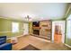 Cozy living room features a brick fireplace, modern lighting, and an open doorway to the kitchen at 110 Sandy Ridge Trl, Fayetteville, GA 30214