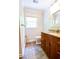 Cozy powder room featuring custom vanity with granite countertop and tile flooring at 110 Sandy Ridge Trl, Fayetteville, GA 30214
