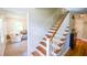 Elegant staircase featuring hardwood steps, white risers and wainscotting at 110 Sandy Ridge Trl, Fayetteville, GA 30214