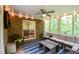 Bright sunroom with comfortable seating, ceiling fan, and views of the surrounding greenery at 110 Sandy Ridge Trl, Fayetteville, GA 30214