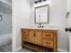 Bathroom features a custom wood vanity with Carrara marble countertop and modern lighting at 1225 Church St # A, Decatur, GA 30030