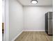 Kitchen with stainless steel fridge and wood-look floors at 1225 Church St # A, Decatur, GA 30030