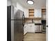 Galley kitchen features stainless steel appliances, stylish granite counters, and modern cabinetry at 1225 Church St # A, Decatur, GA 30030