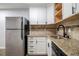 Corner kitchen showcases granite countertops, stainless steel refrigerator and white shaker cabinets at 1225 Church St # A, Decatur, GA 30030